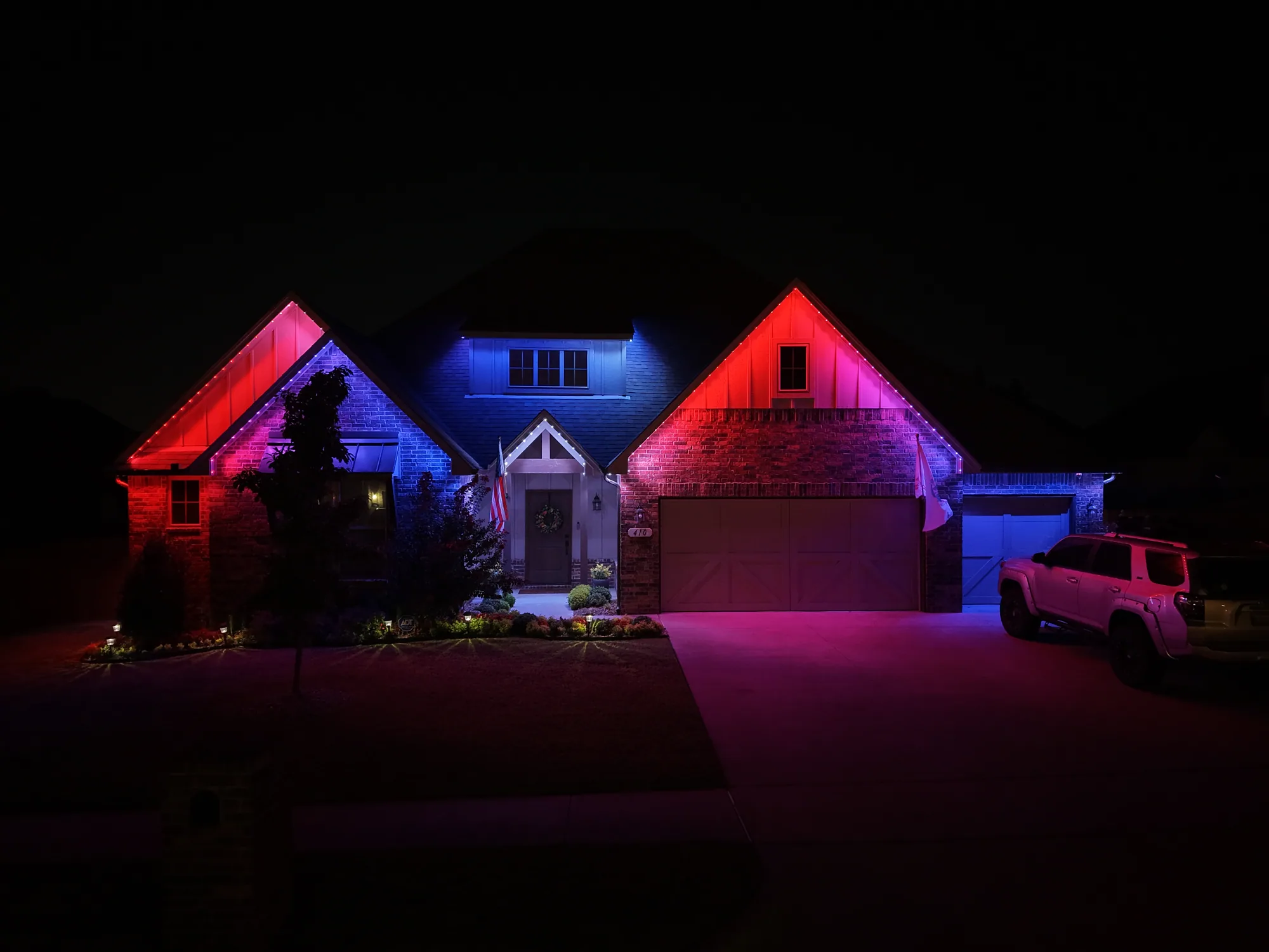 Roofline gables running pink and blue. Permanent Lighting by LIT Outdoor Lighting in Tulsa.