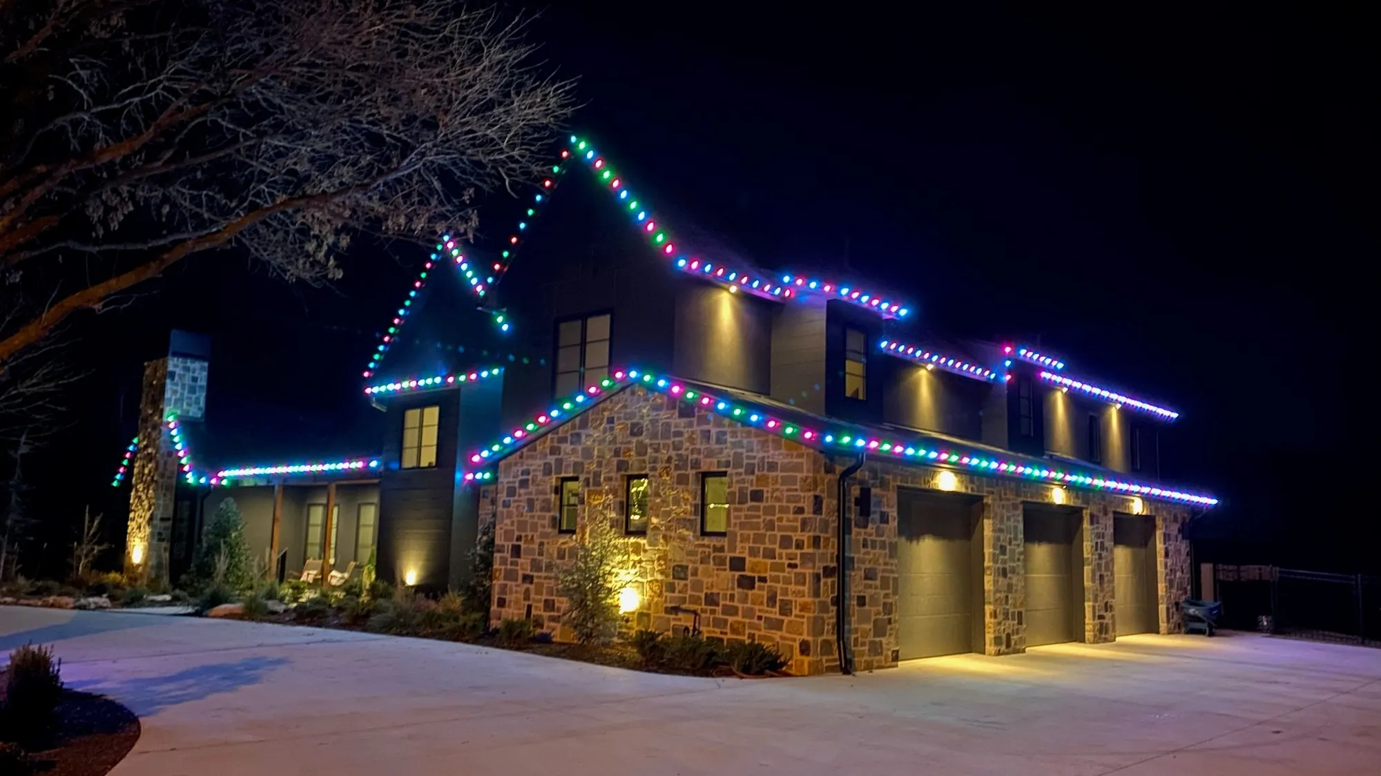 Every roofline on a stone home running colour. Permanent Lighting by LIT Outdoor Lighting in Tulsa.