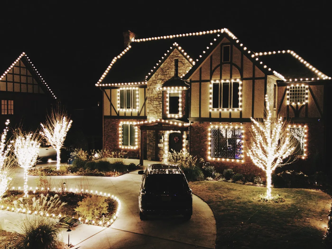 Warm white roofline on a Tudor front. Christmas Lighting by LIT Outdoor Lighting in Tulsa.