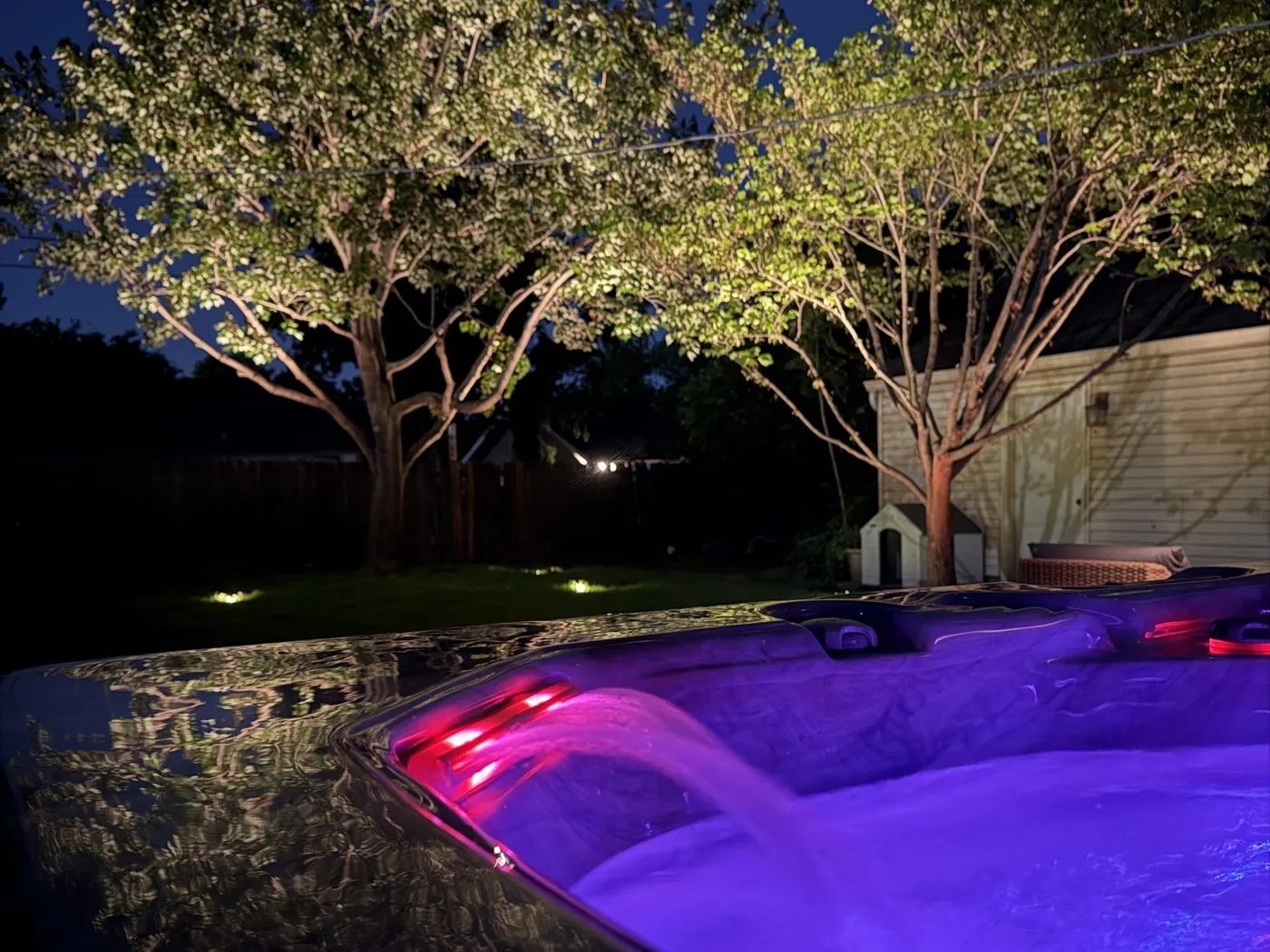 Colour changing light in a pool. Landscape Lighting by LIT Outdoor Lighting in Tulsa.
